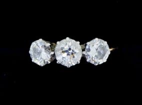 An antique 18 carat gold three stone diamond ring, the central stone approx 0.5 carats, size T, 3.2g