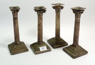 A set of four late 19th century silver plated corinthian column candlesticks, 24cm tall