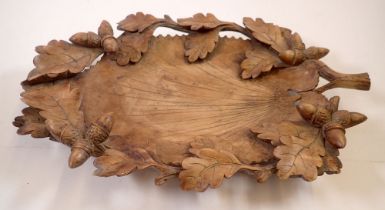 A 19th century Black Forest carved wooden leaf form nut bowl with oak and acorn border, 39 x 26cm