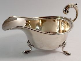 A silver sauce boat with scroll over handle and hoof feet, Birmingham 1939, by S Blanckensee & Son