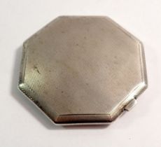 An octagonal silver compact
