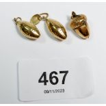 Three 9 carat gold charms including an acorn and two rugby balls, total weight 2.5g