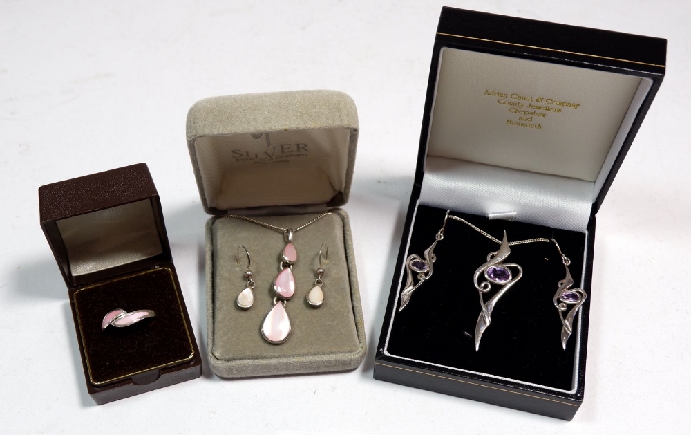 Two silver necklace and earring sets and a ring