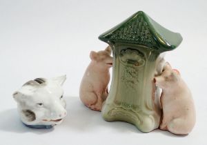 A Victorian porcelain pigs head money box, (chipped ears) and a novelty pig spill vase, 10.5cm tall