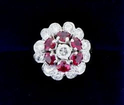 An 18 carat gold ruby and diamond cluster ring, size K, 6.4g
