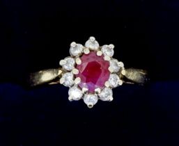 An 18 carat gold ruby and diamond cluster ring, size N, 3.9g