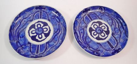 A pair of Japanese blue and white plates painted stylised aquatic decoration