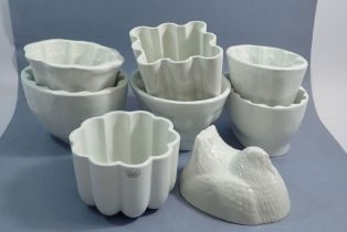 Eight ceramic jelly moulds including one Shelley mould plus a Greens chicken on a basket