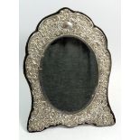 An Edwardian silver easel mirror with embossed decoration, Birmingham 1909 by Henry Matthews, 33 x