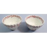 A pair of 18th century English porcelain tea bowls painted flowers with pink ribbon and flower