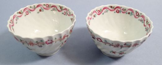 A pair of 18th century English porcelain tea bowls painted flowers with pink ribbon and flower