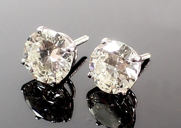 A pair of large 18 carat white gold diamond stud earrings, total 5.2 carats with screw backs