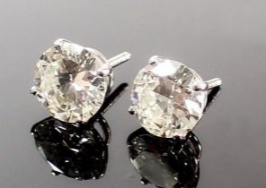 A pair of large 18 carat white gold diamond stud earrings, total 5.2 carats with screw backs
