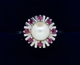 A vintage 14k white gold ring set pearl within star and red stone surround, 2.8g, size P to Q