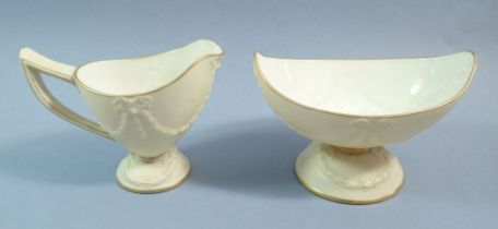 A Royal Worcester boat form cream and gilt sugar bowl and jug with swag decoration, No.1530
