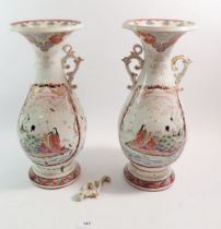 A pair of late 19th century Chinese two handled vases with flared rims and painted panels of