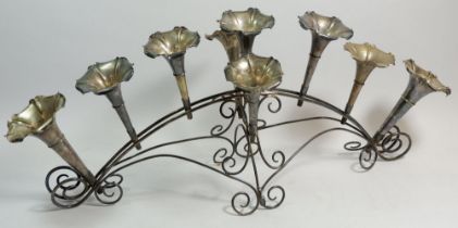 A silver plated and cut glass nine vase epergne on linear scrollwork stand, 64cm wide