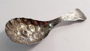 A silver caddy spoon with floral embossed decoration by George Unite, Birmingham 1871