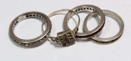 A silver 935 paste ring and three other silver rings