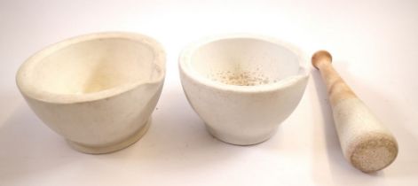 Two antique pestles and one mortar, 17cm diameter