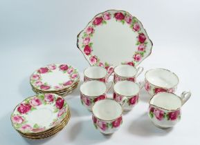 A Royal Albert Old English Rose tea service including five cups and saucers, six side plates, one