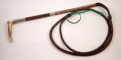 A horn handled riding crop and whip