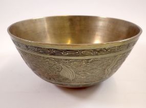 A Chinese brass bowl decorated dragon and waves, cast mark to base, 24cm