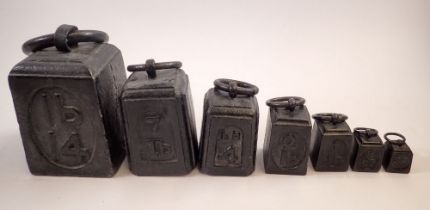 A set of seven cast iron weights - 4ozs to 14lbs