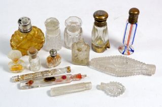 A collection of small antique glass scent bottles etc one with hinged metal compartment to base