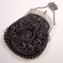 A Victorian evening bag with silver plated clasp decorated horse racing scenes and jockeys
