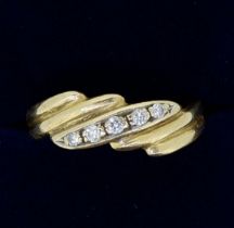 A gold ring crossover set five diamonds, size N-O, 3.6g