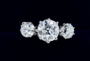A fine quality platinum set three stone diamond ring, 2.5 cts in total, size M