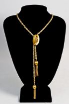 An 18 carat gold and white metal spiral link and tassel necklace with oval adjustable clasp