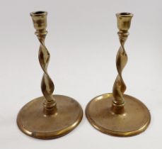 A pair of antique brass spiral turned candlesticks, 23cm