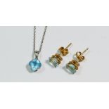 An 18 carat white gold pendant necklace with blue topaz drop and a pair of yellow metal stud