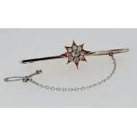 An antique 18 carat and 15 carat white and yellow gold bar brooch with diamond set star and safety