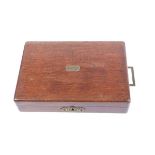 A mahogany pistol box with campaign handle and vacant brass name plate, the fitted interior to