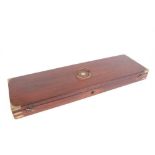 Brass mounted mahogany gun case with brass inset ring handle with green baize fitted interior for