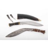 Two khukri's, the first with a 10 ins single fullered heavy blade with buffalo horn and brass