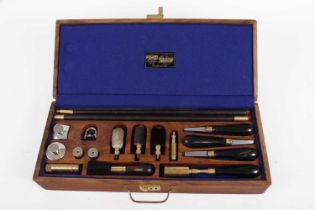 Cased William Powell 12 bore shotgun cleaning kit including chamber brush, choke gauge, cartridge