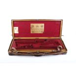 A good oak and leather double gun case with reinforced brass corners, fully fitted red baize