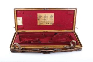 A good oak and leather double gun case with reinforced brass corners, fully fitted red baize