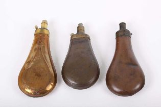 3 Various copper and brass powder flasks with external springs, either plain, rib edged or