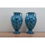 A pair of large antique Middle Eastern glazed terracotta twin handled vases, blue floral glaze, both