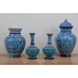 Two pairs of antique Middle Eastern glazed terracotta vases, all with blue and white floral