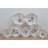 A collection of continental porcelain plates, comprising four plates with floral painted design