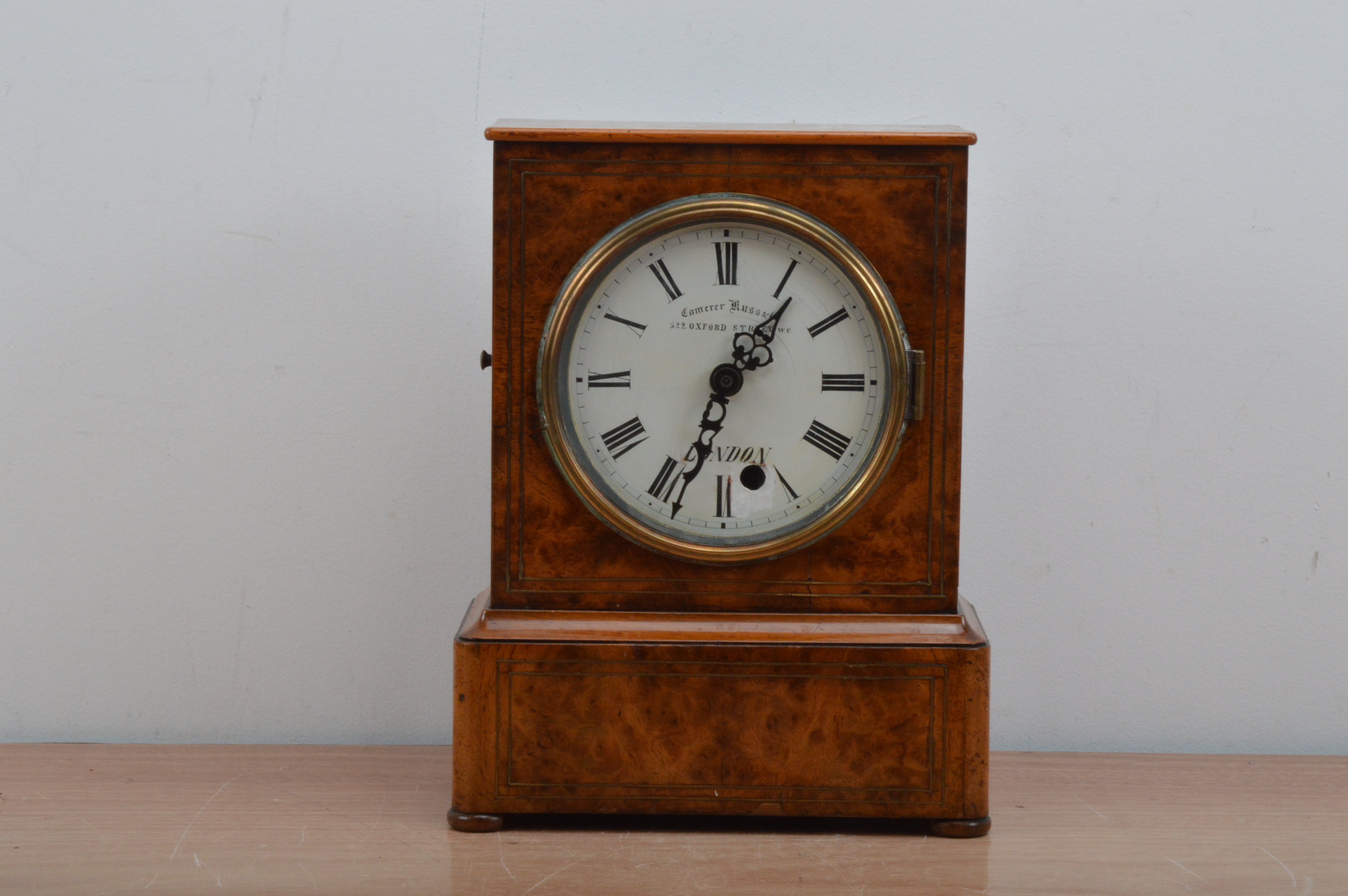 A 19th century burr walnut cased mantel clock, retailed by Camerer Russ & Co, 522 Oxford Street,