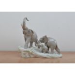 Lladro ceramic figural group, of three elephants, on a naturalistic base, marked to the underside,