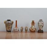 A collection of Japanese ceramics, comprising a twin handled vase, black ground with heightened gilt