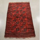 A middle-eastern wool on wool rug, red elephant foot design, some wear AF, 184cm x 110cm